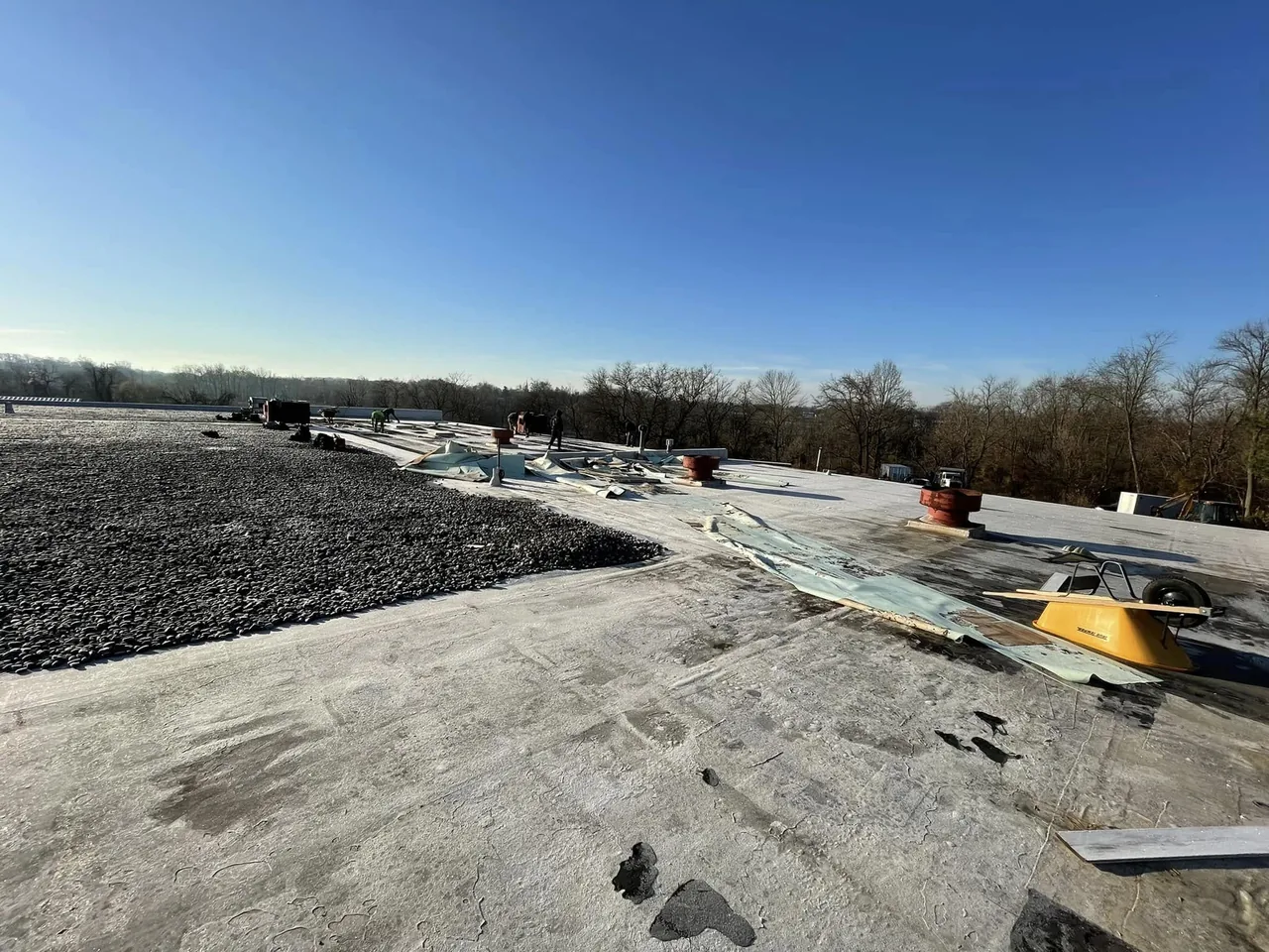 Old flat roof being stripped on a large commercial roofing project