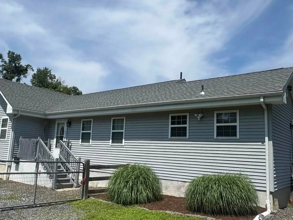 New gray asphalt shingle roof on a gray sided ranch home, roof replacement