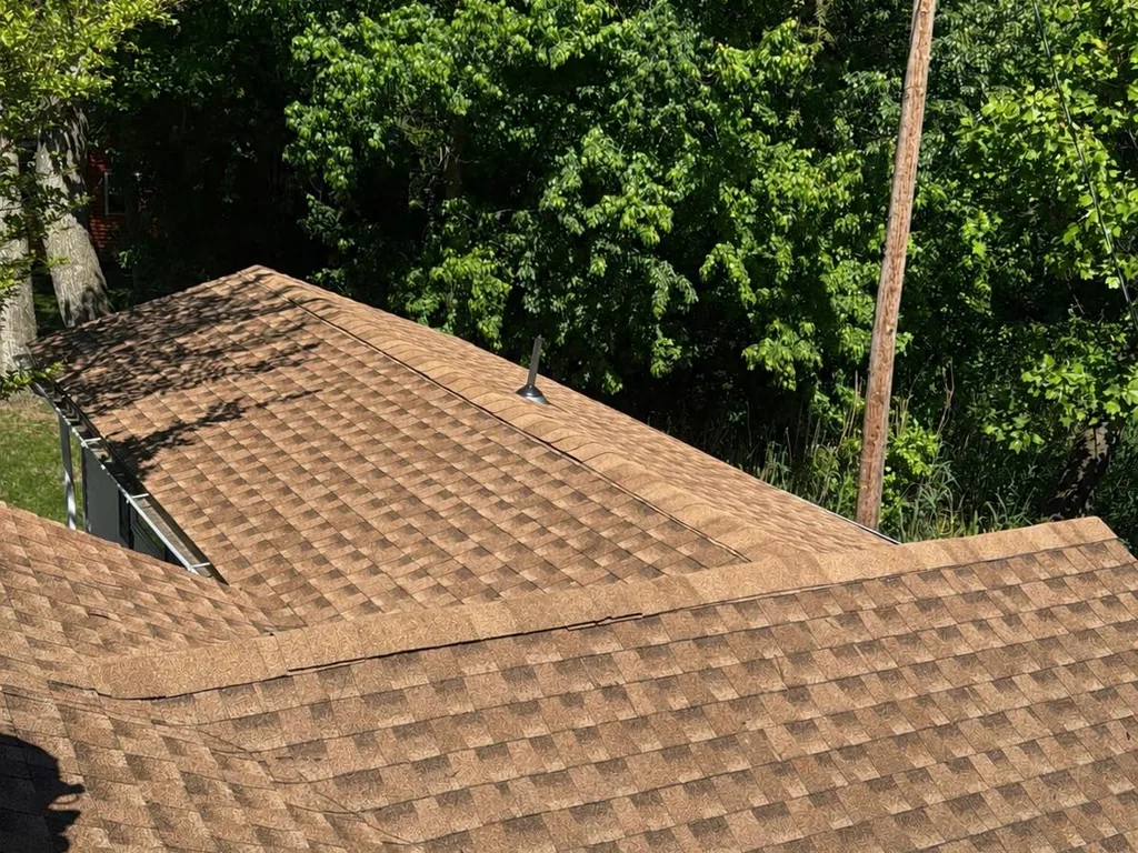 Close view of new Shakewood asphalt shingles on a hip roof, roof replacement