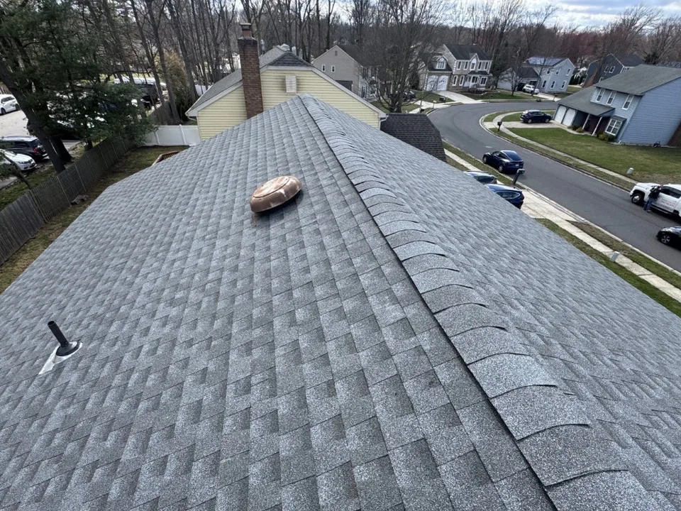 View down a new Pewter Gray asphalt shingle roof toward the street, roof replacement