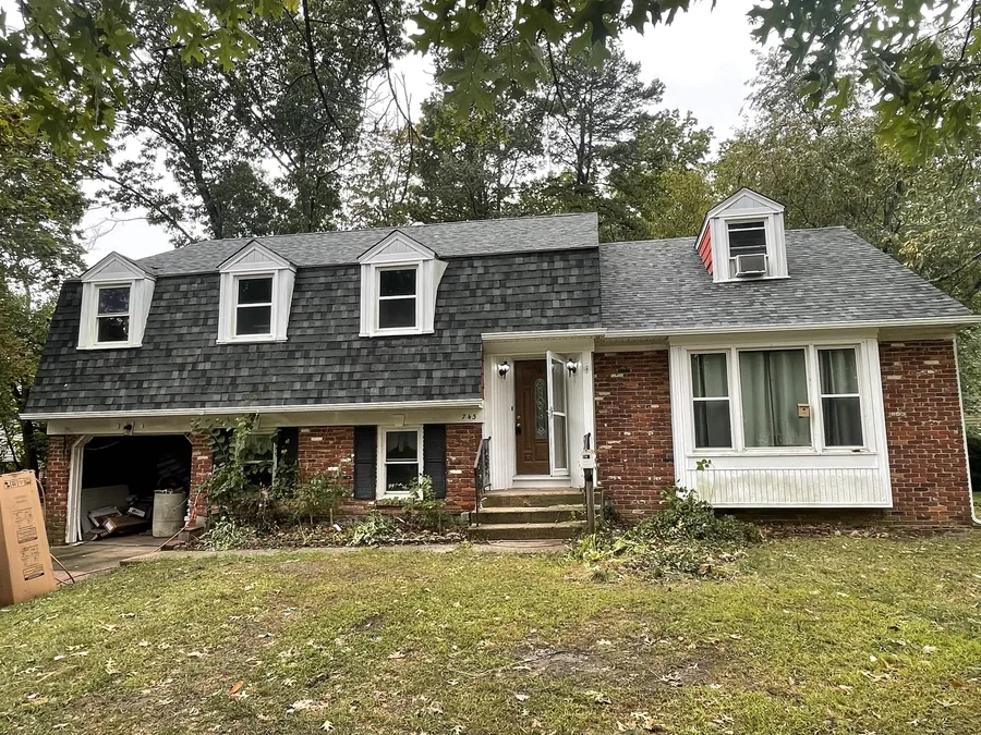 Cape home with dormers, a new roof and new gutters, gutter installation