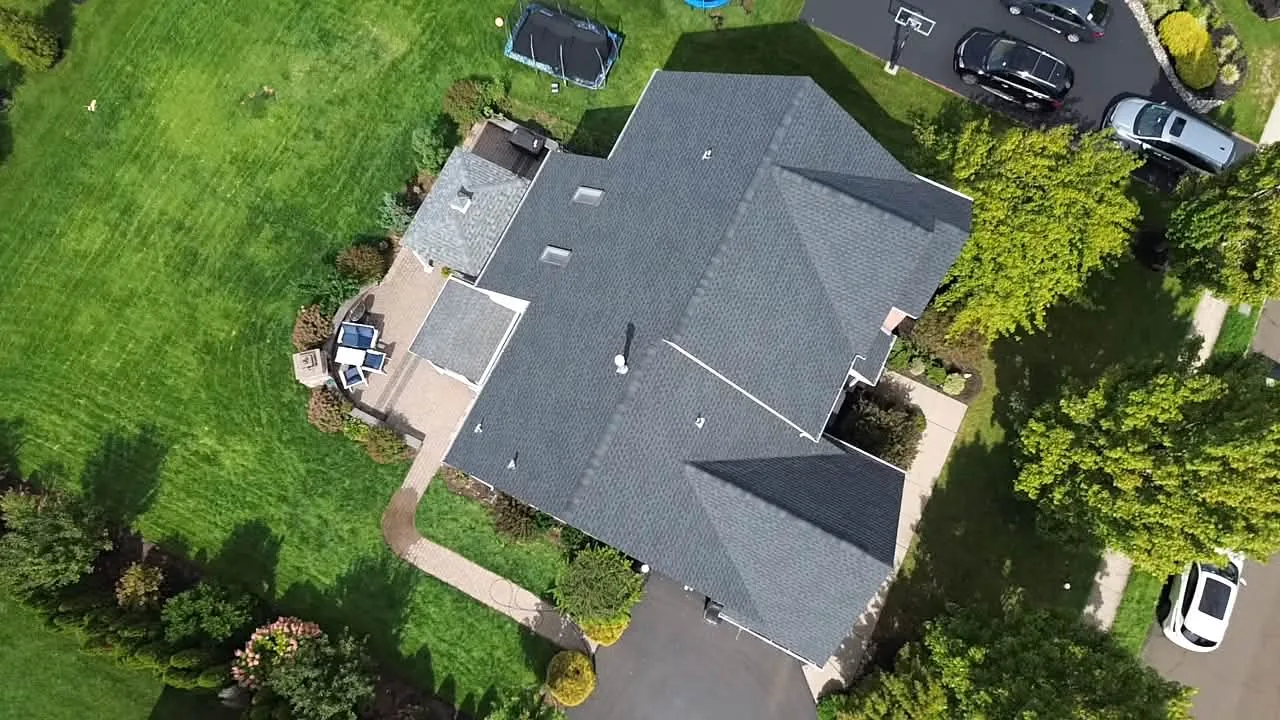 Our work: a finished asphalt shingle roof on a two story home seen from the drone, roof replacement