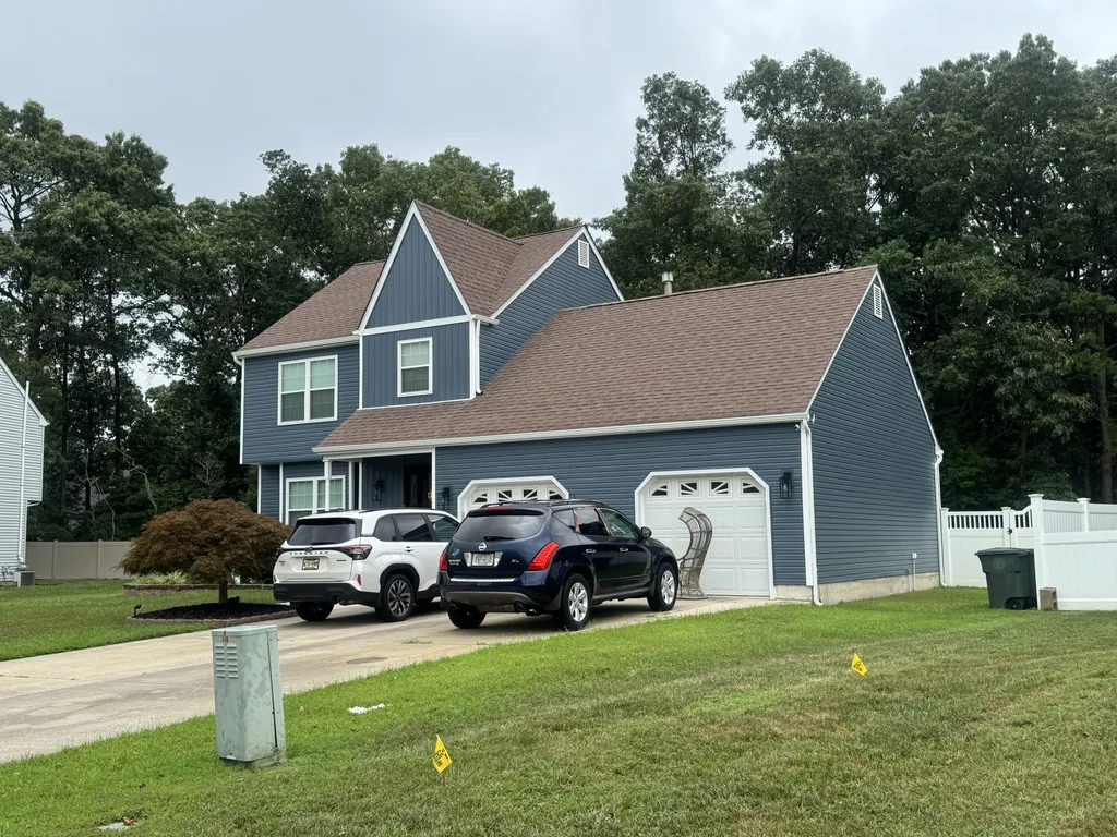 New blue siding on a two story home with a garage, siding contractor