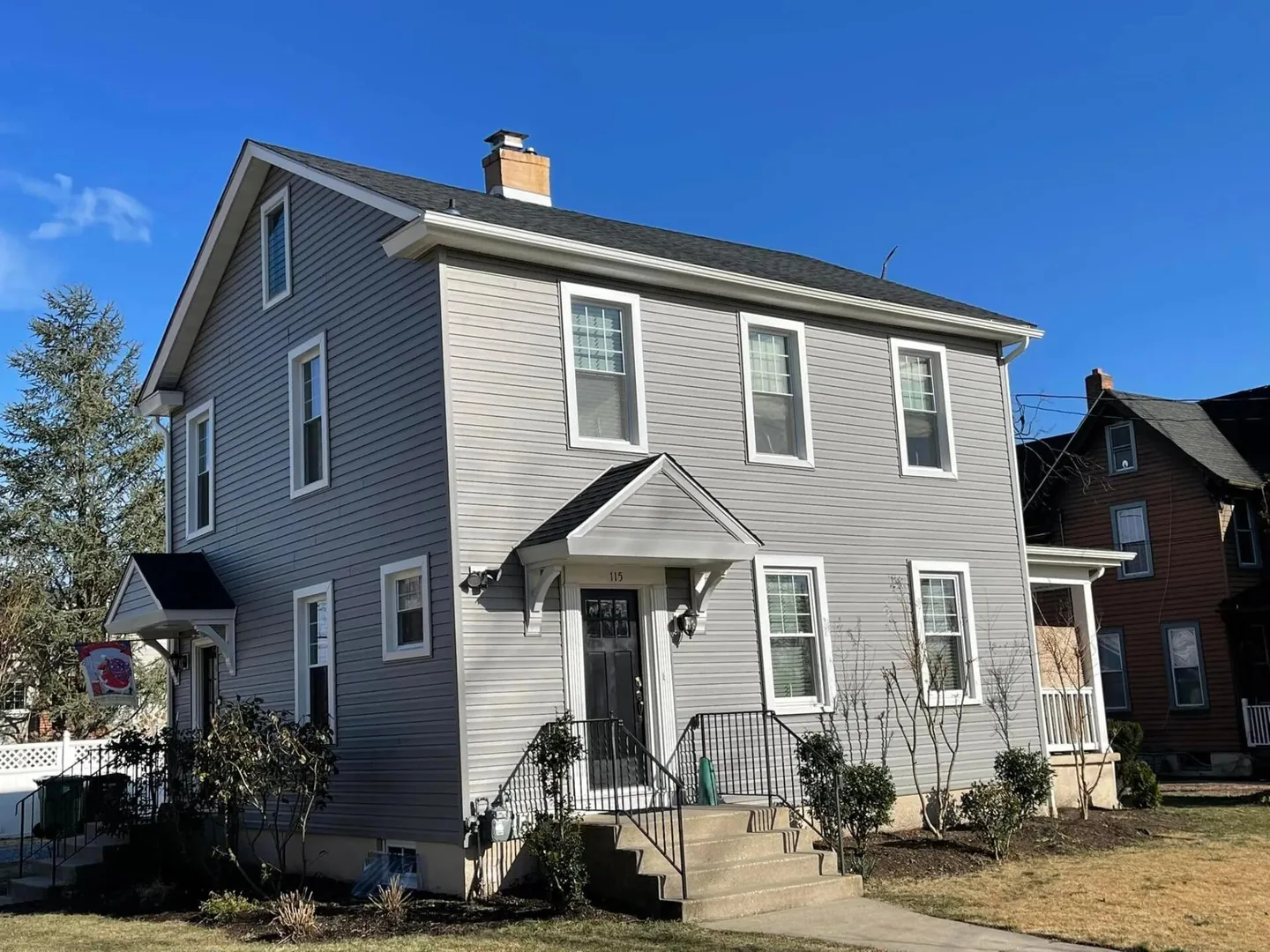 Gray siding with white trim on a two story colonial, siding contractor